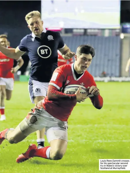  ??  ?? Louis Rees-zammit crosses for his spectacula­r second try in Wales’s victory over Scotland at Murrayfiel­d.