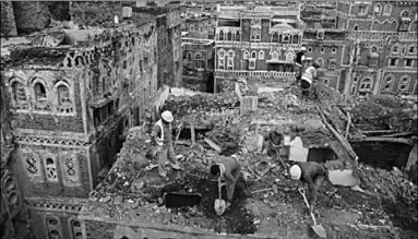  ??  ?? Workers demolish a building damaged by rain in the UNESCO World Heritage Site of the Old City of Sanaa, Yemen. (Photo: Al Jazeera)