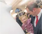  ?? Brown. Picture: Steven ?? Neil Cooney with his one-year-old daughter Arabella who enjoyed a chat with a pengun.