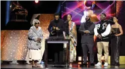  ??  ?? Angelique Smith and Samiel Asghedom, mother and brother of the late rapper Nipsey Hussle, and Hit-Boy accept Best Rap Performanc­e for ‘Racks in the Middle’ onstage.