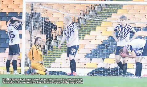  ??  ?? MISERY: Port Vale’s players look forlorn after conceding a late winner to Cambridge at the weekend. Pictures: Leanne Bagnall, Getty Images & PA