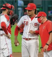  ?? DAVID JABLONSKI / STAFF ?? Pitching coach Derek Johnson (here with catcher Curt Casali and pitcher Luis Castillo during a game Tuesday against the Royals) is alarmed by the increase in injuries to pitchers this season.