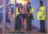  ?? REX FEATURES VIA AP ?? Police help the injured late Monday after multiple reports of an explosion at Manchester Arena in northern England.