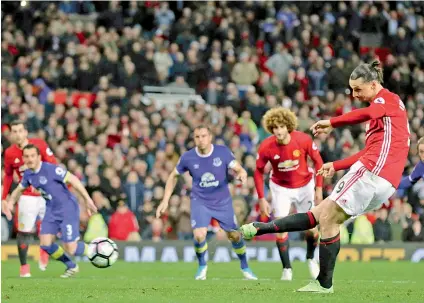  ?? — AP ?? Manchester United’s Zlatan Ibrahimovi­c scores against Everton in their English Premier League match at Old Trafford on Tuesday.