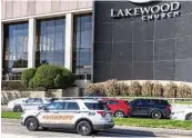  ?? KIRK SIDES / HOUSTON CHRONICLE ?? Emergency vehicles line the feeder road outside Lakewood Church during a reported active shooter event Sunday in Houston. A woman was killed after she opened fire at the church.