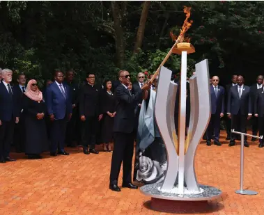  ?? ?? President Paul Kagame lit a flame of remembranc­e at a memorial to the victims of the 1994 Rwandan massacre