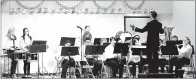  ?? Westside Eagle Observer/MIKE ECKELS ?? The Decatur High School band performs “Three More Christmas Parades” by Allen Gray as its last selection during the 2017 Decatur Public School District’s winter concert in the cafeteria at Northside Elementary on Dec. 13.