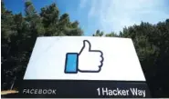  ?? AP FILE PHOTO/JEFF CHIU ?? The thumbs up Like logo is shown on a sign at Facebook headquarte­rs in Menlo Park, Calif. As President Donald Trump denies that Russia is interferin­g in the U.S. election and as he tries to block informatio­n to Congress, private companies such as Microsoft and Facebook are stepping into the breach.