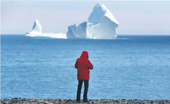  ??  ?? A large iceberg floats off the shore in Ferryland, an hour south of St. John's, on Monday.