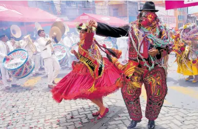  ?? AP ?? Revellers dance on the closing day of Carnival in La Paz, Bolivia, on Sunday, February 18.