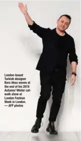 ??  ?? London-based Turkish designer Bora Aksu waves at the end of his 2019 Autumn/ Winter catwalk show at London Fashion Week in London. — AFP photos