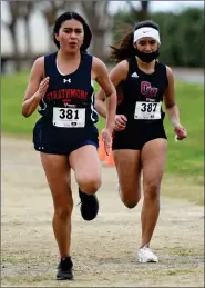  ?? RECORDER PHOTO BY NAYIRAH DOSU ?? Strathmore High School’s Alondra Morales, left, edges out Granite Hills High School’s Lupe Trejo for first in a head-to-head race at an East Sequoia League meet, Thursday, March 11, 2021, at the Portervill­e Sports Complex.