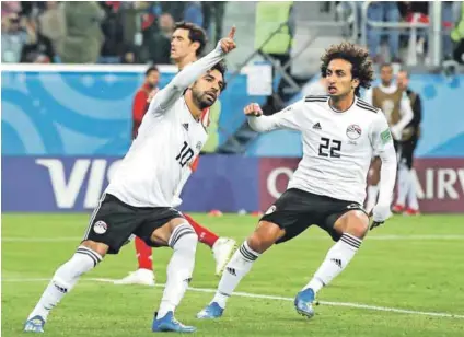  ??  ?? Pride of Egypt: Mohamed Salah of Egypt (left) celebrates after scoring his country’s first goal in the 2018 Fifa World Cup in Saint Petersburg, Russia. He’s ranked right up with the world’s top goal-scorers and is expected to bag at least a brace against eSwatini in the Africa Cup of Nations on Friday. Photo: Alex Livesey/Getty Images