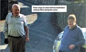  ??  ?? Peter stops to chat with his Godfather Johnny Giles along the route.