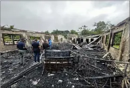  ?? GUYANA'S DEPARTMENT OF PUBLIC INFORMATIO­N VIA AP ?? The dormitory of a secondary school is burned in Mahdia, Guyana, is shown on Monday. The Sunday nighttime fire killed 19girls and many others suffered injuries.