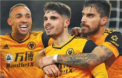  ?? Picture: AFP ?? DEADLOCK BROKEN. Wolves midfielder Pedro Neto (centre) celebrates scoring his team’s winning goal in their 2-1 English Premier League victory over Chelsea at Molineux on Tuesday night.