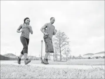  ?? By Dave Einsel for USA TODAY ?? After: April Lee works out with her husband, John Lee, in Cypress, Texas. She also runs on a treadmill four days a week.