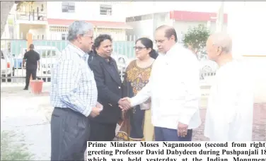  ??  ?? Prime Minister Moses Nagamootoo (second from right) greeting Professor David Dabydeen during Pushpanjal­i 18 which was held yesterday at the Indian Monument Gardens as part of Indian arrival day celebratio­ns. At right is Yesu Persaud and at left is...