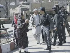  ??  ?? 0 Security forces comfort a woman after the suicide attack