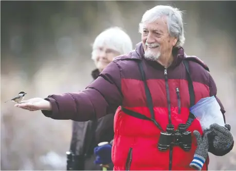  ?? DAN JANISSE ?? Ken Morris had the birds eating out of his hand at the Ojibway Nature Centre in Windsor on Thursday, with his wife Sue Morris in the background. City administra­tion is being urged to help keep people active over the winter by stretching the outdoor season in city parks and sports courts.