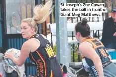  ?? ?? St Joseph’s Zoe Cowan takes the ball in front of Giant Meg Matthews.