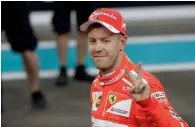  ?? AP ?? Ferrari driver Sebastian Vettel, of Germany, smiles after setting third fastest time during the qualifying session. —