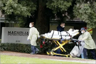  ?? CHRIS CARLSON — THE ASSOCIATED PRESS ?? A patient at Magnolia Rehabilita­tion and Nursing Center in Riverside is taken to an ambulance on April 8.