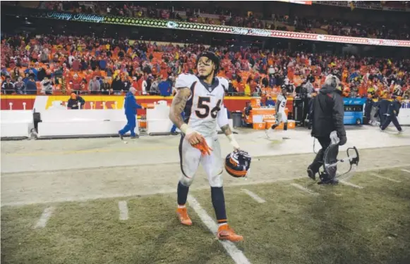  ??  ?? Broncos outside linebacker Shane Ray walks off the field at the end of the game Sunday night at Arrowhead Stadium after Denver was eliminated from the postseason for the first time since the 2010 season, when Kyle Orton was the starting quarterbac­k and...