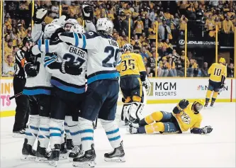  ?? MARK HUMPHREY THE ASSOCIATED PRESS ?? Winnipeg players celebrate after tying the game against the Nashville Predators on Sunday in Nashville, Tenn. The Predators won 5-4 to split the first two games in Nashville.