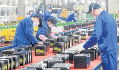  ?? STR/AFP ?? This photo taken on March 30, 2020 shows employees working on a battery production line at a factory in Huaibei in China’s eastern Anhui province.