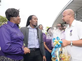  ??  ?? In conversati­on are (from left) Prim Lewis, principal of deCartert College; Alando Terrelonge, state minister in the Ministry of Culture, Gender, Entertainm­ent, and Sports; and Rohan Walcott, director of the deCartert College.