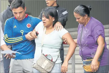  ?? ARIANA CUBILLOS — THE ASSOCIATED PRESS ?? Barbara Barca, a survivor of the stampede at a crowded nightclub, is helped by relatives as they leave police headquarte­rs in Caracas, Venezuela, on Saturday.