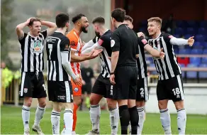  ?? ?? Romans players ask for a penalty after Cody Cooke’s foot was seemingly swiped away