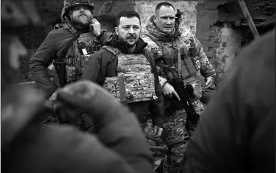  ?? UKRAINIAN PRESIDENTI­AL PRESS OFFICE VIA AP ?? Ukrainian President Volodymyr Zelenskyy, centre, visits Zaporizhzh­ia region, the site of fierce battles with the Russian troops in Ukraine, on Sunday.