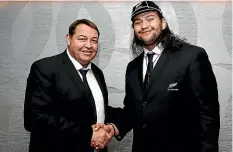  ??  ?? Tyrel Lomax receives his test cap from All Blacks coach Steve Hansen.