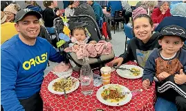  ?? DEBBIE JAMIESON / STUFF ?? Left: Darlan Caetano, with Hannah, 9 months, Taina, and Henry, 4, are regulars at the Queenstown Pasta Cafe where they can relax and have a night off cooking.
Below: Attraction­s include cheerful volunteers such as Janet Rutherford and, of course, the heaving home baking table.