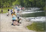  ?? NWA Democrat-Gazette/FLIP PUTTHOFF ?? Anglers fish on July 7 along the ice-cold Roaring River at Roaring River State Park northeast of Seligman, Mo.