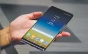  ?? Drew Angerer, Getty Images ?? A man gets his hands on Samsung’s new Galaxy Note 8 smartphone. The previous Galaxy Note 7 model had to be recalled because of self-combusting batteries.