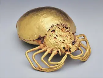  ??  ?? A late 19th-century gold-copper-silver alloy sword ornament in the form of the spider god Ananse, the trickster.