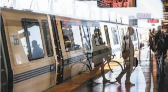  ?? Amy Osborne / Special to The Chronicle ?? MacArthur BART Station in Oakland is one of the older stops, part of the more urban inner system. The BART Board of Directors recently voted down a Livermore extension.