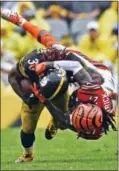  ?? DON WRIGHT — THE ASSOCIATED PRESS ?? Steelers running back DeAngelo Williams (34) is tackled by Cincinnati Bengals cornerback Dre Kirkpatric­k (27) during the second half of an NFL game Sunday in Pittsburgh.