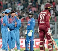  ?? AP ?? India’s Kuldeep Yadav (without cap) celebrates the dismissal of Carlos Brathwaite with his teammates. —