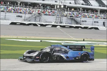  ?? ASSOCIATED PRESS ?? FILIPE ALBUQUERQU­E DRIVES HIS ACURA DPI out pit road to the track after his last pit stop in the Rolex 24 hour auto race at Daytona Internatio­nal Speedway on Sunday in Daytona Beach, Fla.