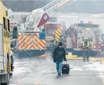  ?? DAVID MCKEOWN/AP ?? Dane Groszek of Middletown N.Y., makes his way off Interstate 81 after his car was totaled in a multi-vehicle crash along the northbound lanes near Minersvill­e on March 28.