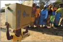  ?? TSVANGIRAY­I MUKWAZHI — THE ASSOCIATED PRESS ?? A child carries a parcel from the United Nations’ World Food Program in Mwenezi, Zimbabwe, in 2015.