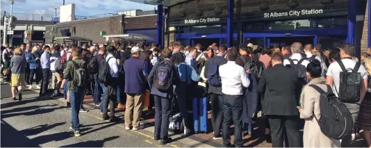 ??  ?? Shut out: Passengers outside St Albans station yesterday after staff closed the gates to prevent platform overcrowdi­ng