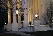  ?? GERALD HERBERT — THE ASSOCIATED PRESS ?? A U.S. Secret Service guard stands post at the North Portico of the White House, after the U.S. House impeached President Donald Trump in Washington on Wednesday.