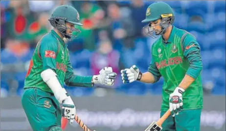  ?? GETTY IMAGES ?? Shakib Al Hasan (left) and Mohammad Mahmudulla­h punch gloves during their partnershi­p against New Zealand in Cardiff on Friday.