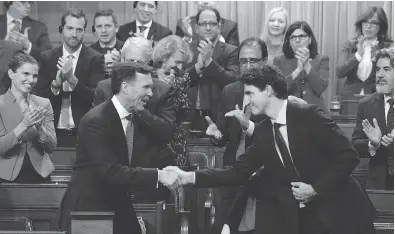  ?? ADRIAN WYLD / THE CANADIAN PRESS ?? Finance Minister Bill Morneau shakes hands with Prime Minister Justin Trudeau after delivering his fall economic statement. In its quest to deliver on promises, the Trudeau government has abandoned its plan of allowing ministers more freedom, with...