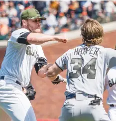  ?? (Reuters) ?? SAN FRANCISCO GIANTS relief pitcher Hunter Strickland (left) and Washington Nationals right fielder Bryce Harper (right) in a fight after Harper was hit by the pitch of Strickland during the eighth inning at AT&T Park on Monday.